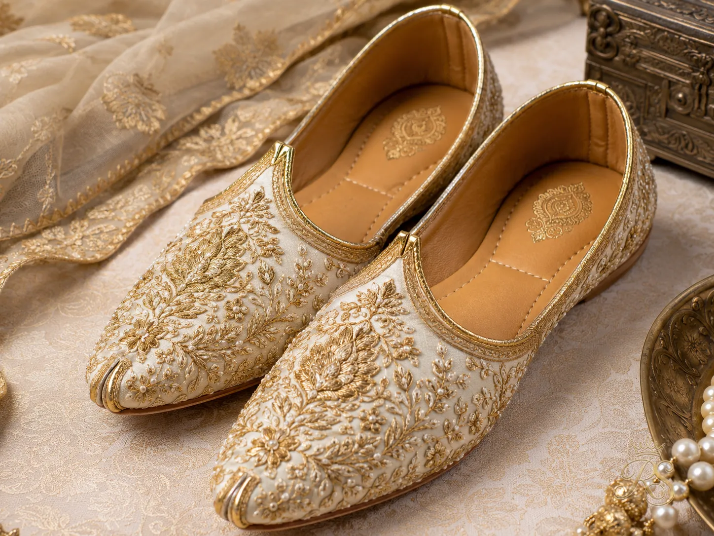 Intricate hand-embroidered mojri shoes for Indian groom in gold and ivory