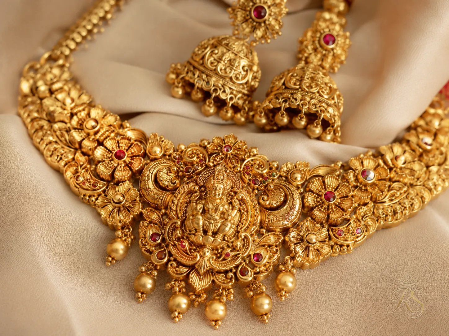 Closeup of South Indian temple-style gold jewellery with floral motifs