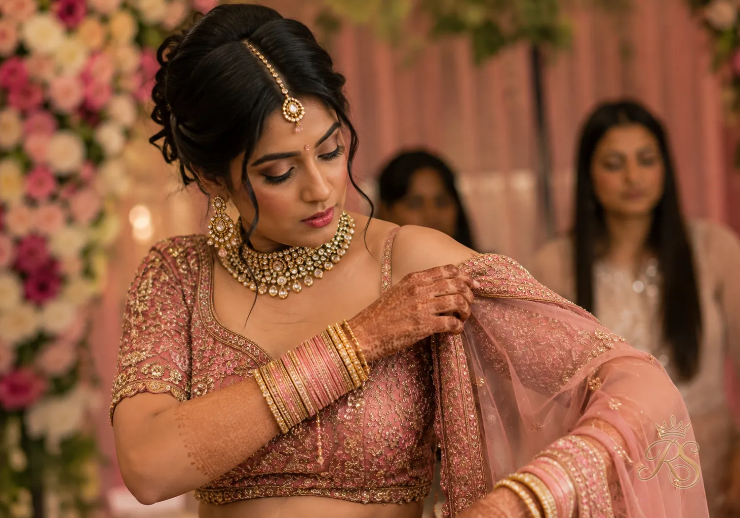 Bride adjusting a slipping dupatta drape, illustrating a common bridal styling mistake