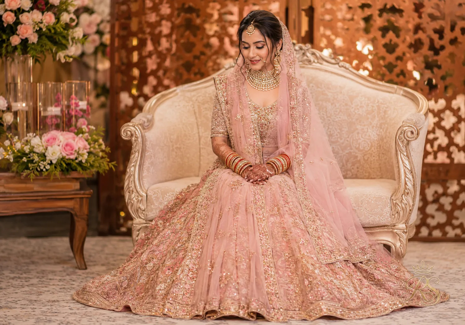 Bride with a front pallu dupatta drape falling in soft pleats down the front of her lehenga