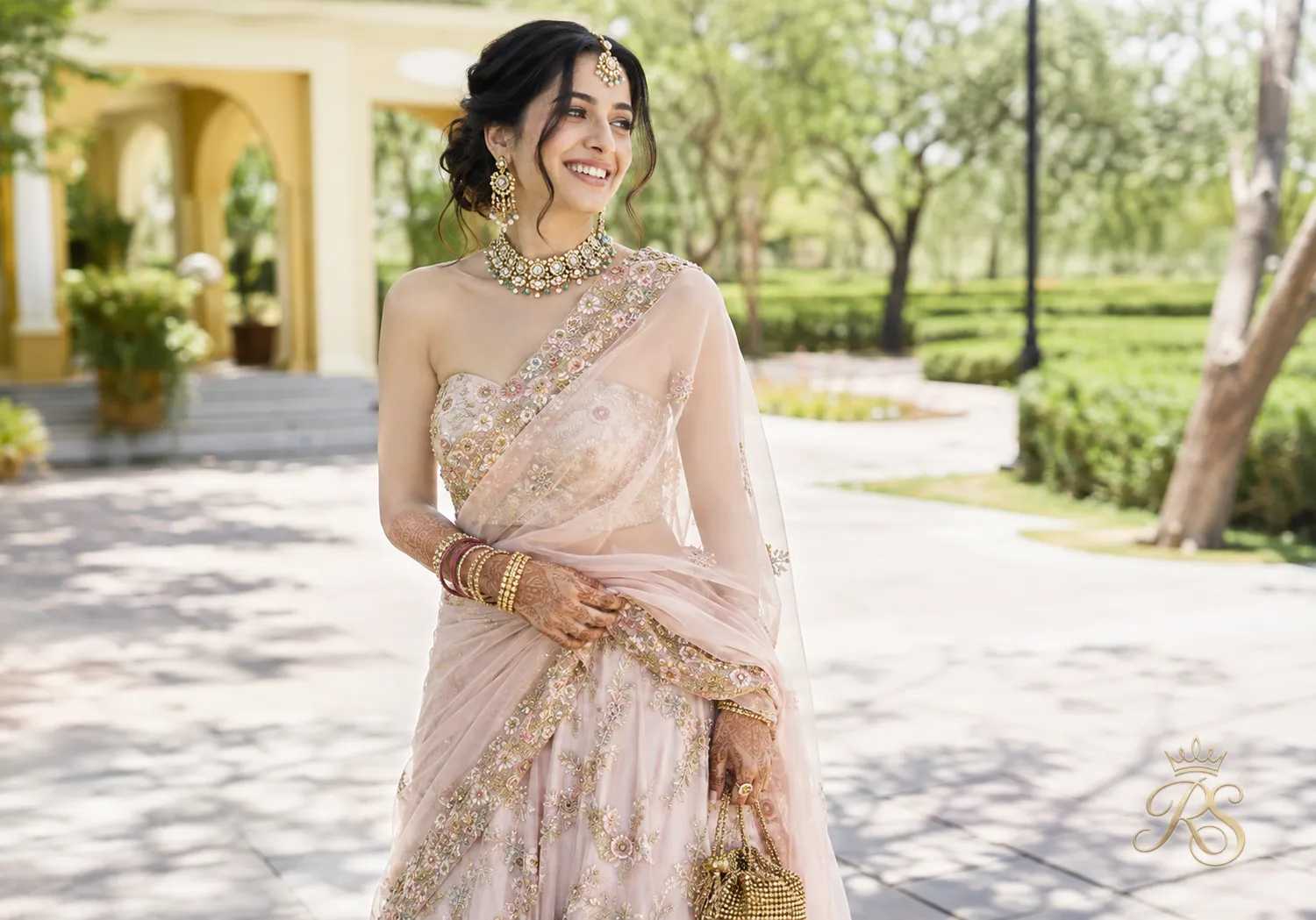 Bride wearing a relaxed one-shoulder dupatta drape with loose pleats