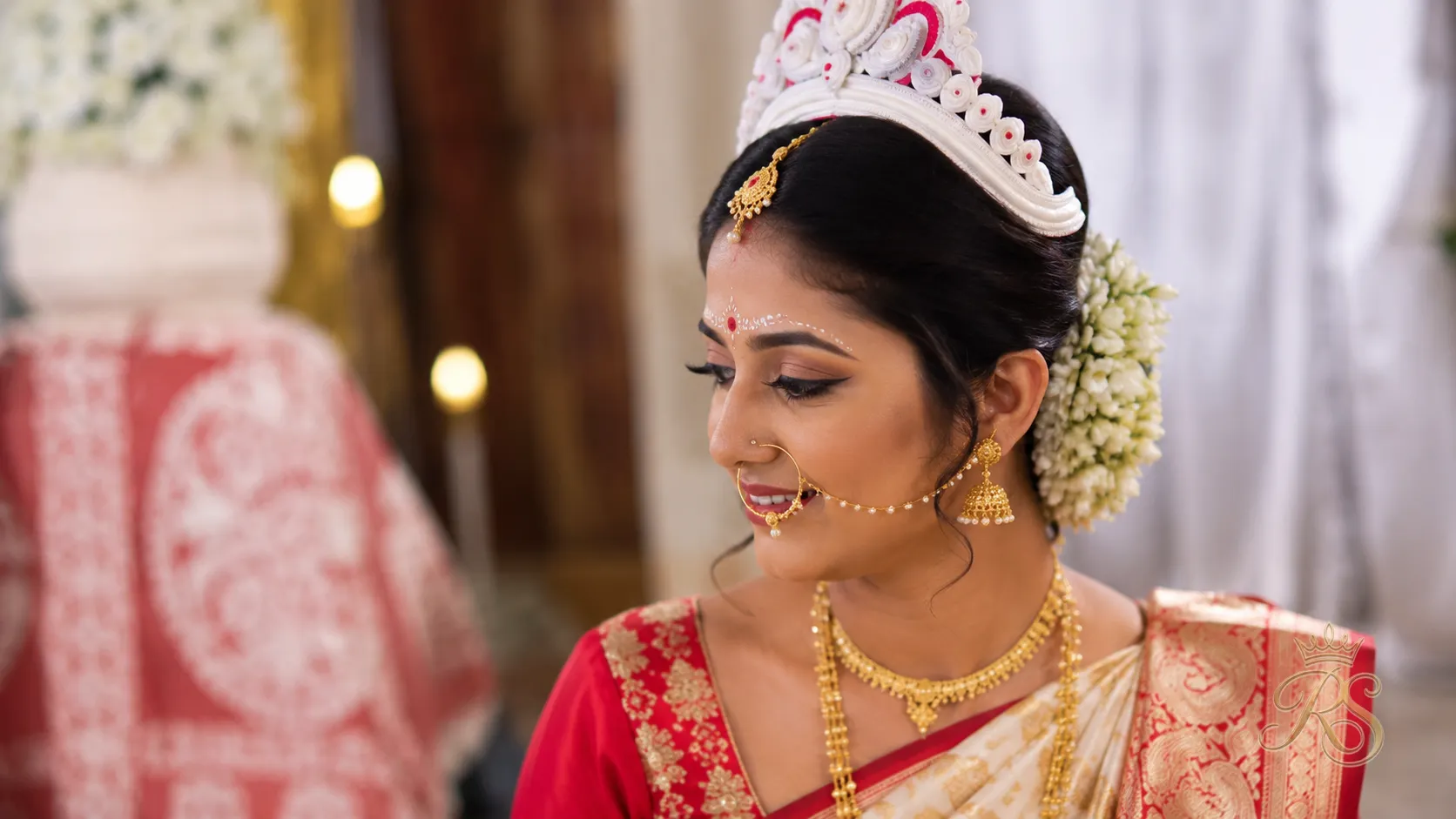Bengali bride wearing a traditional mukut headpiece over a styled bun