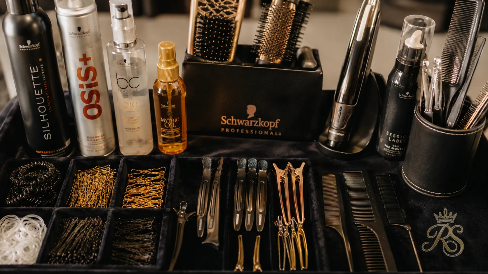 Professional bridal hairstylist's tools and kit laid out before a wedding