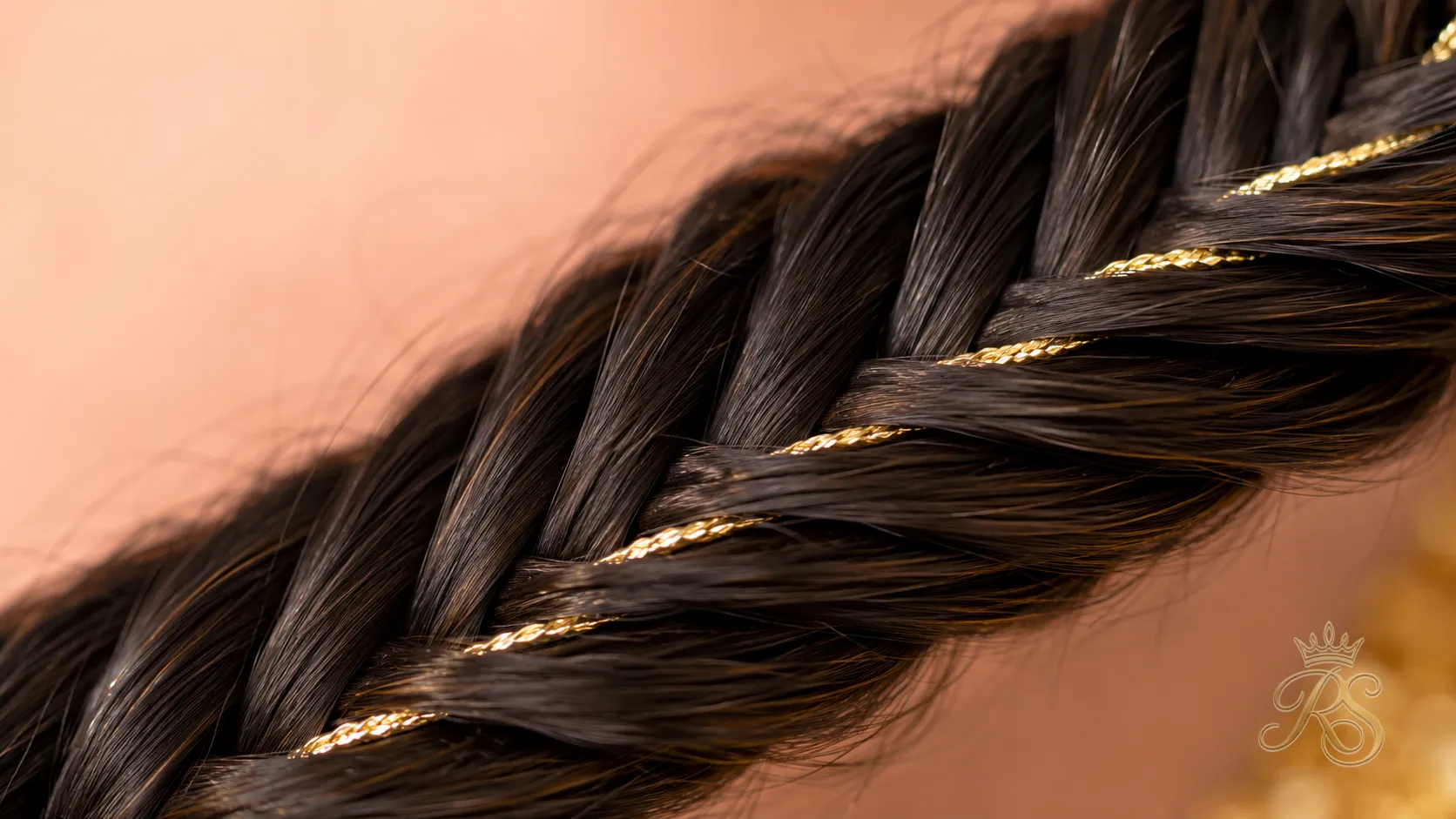 Close-up detail of a fishtail braid with gold thread woven through
