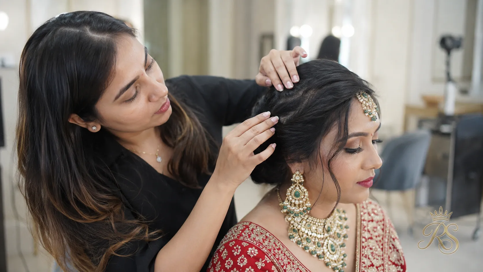 Hairstylist examining a bride's hair texture and scalp during a consultation
