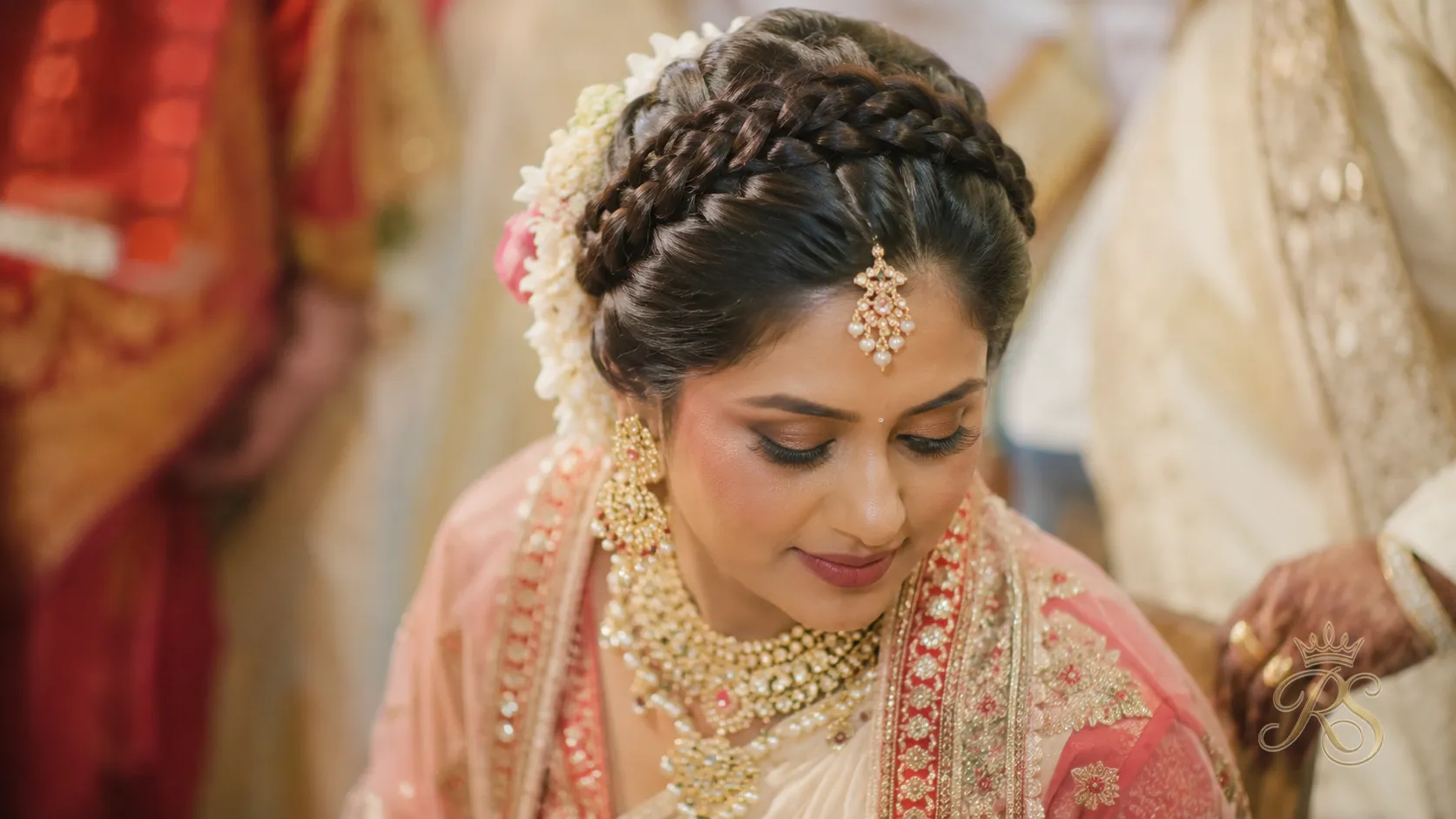 Bride with an intricate braided crown hairstyle for her wedding ceremony