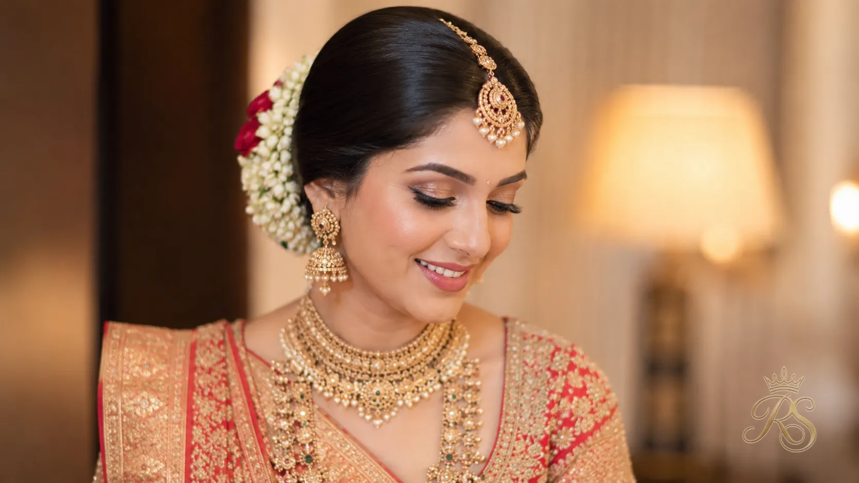 Bride with a classic netted low bun styled for wedding jewelry placement