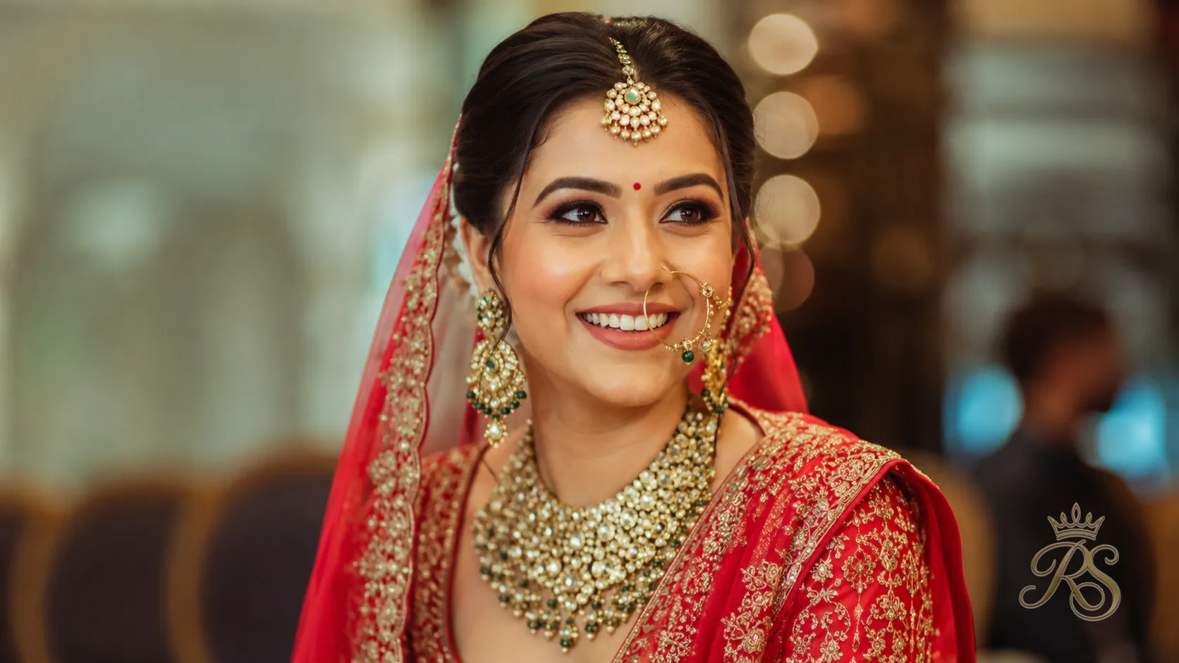Radiant Indian bride in full bridal jewellery and outfit smiling on her wedding day