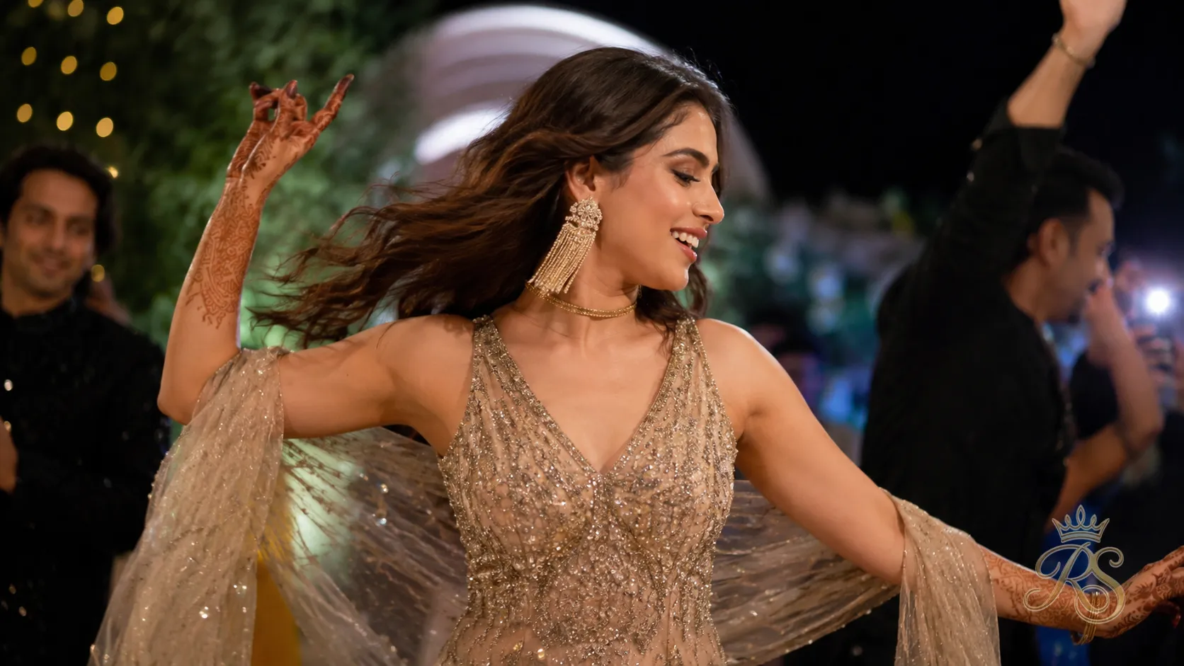 Bride at sangeet wearing statement fringe earrings and a slim choker