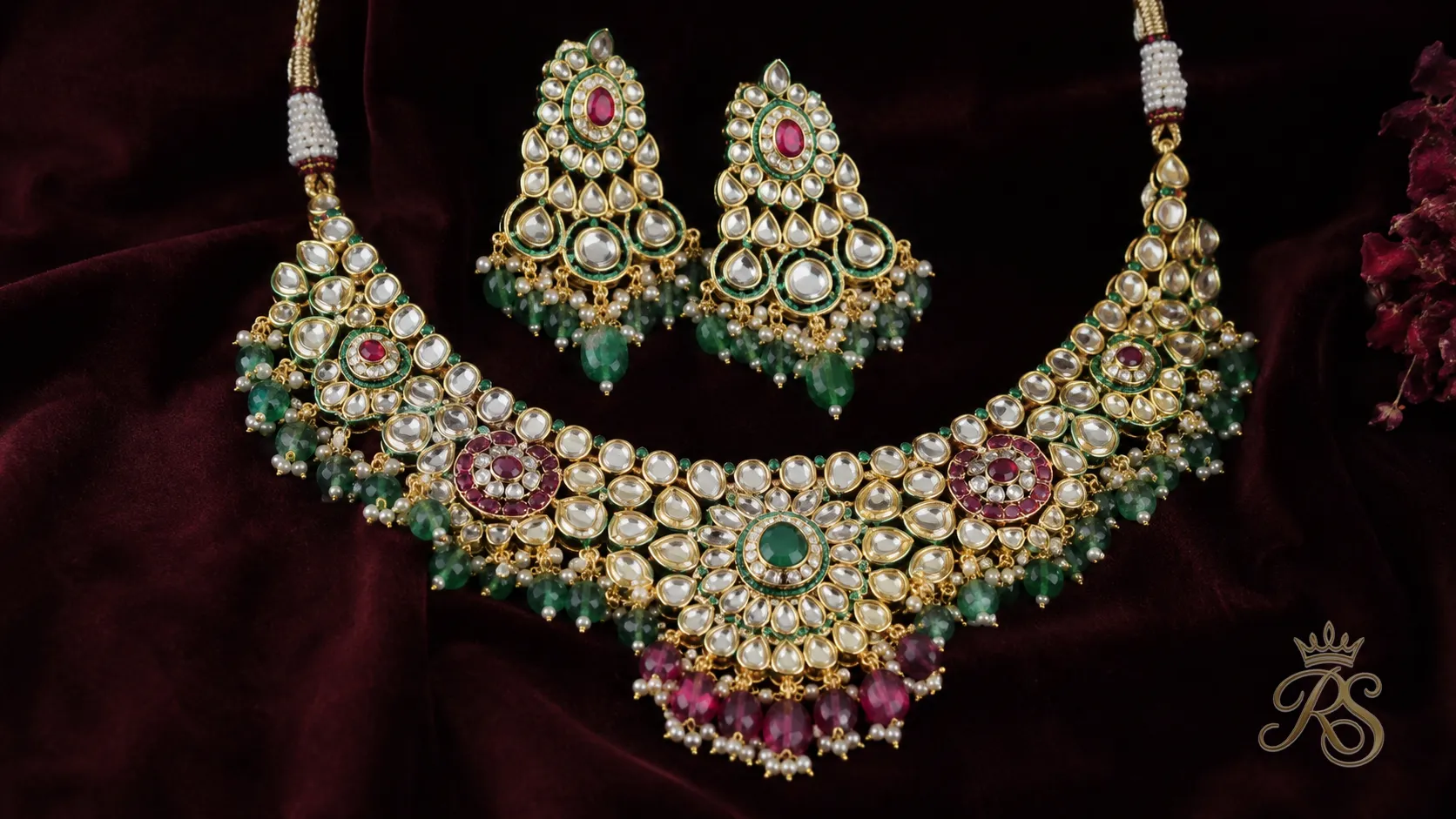 Bridal necklace set featuring polki diamonds mixed with emerald and ruby coloured stones
