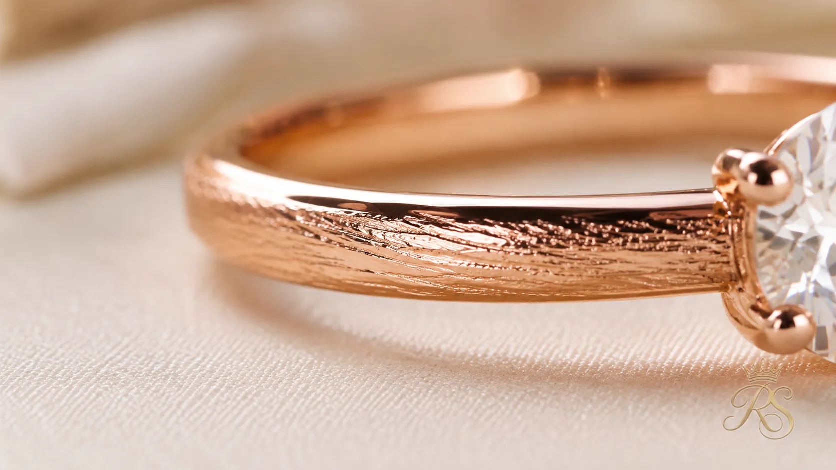Macro close-up of a rose gold ring band showing its warm textured finish