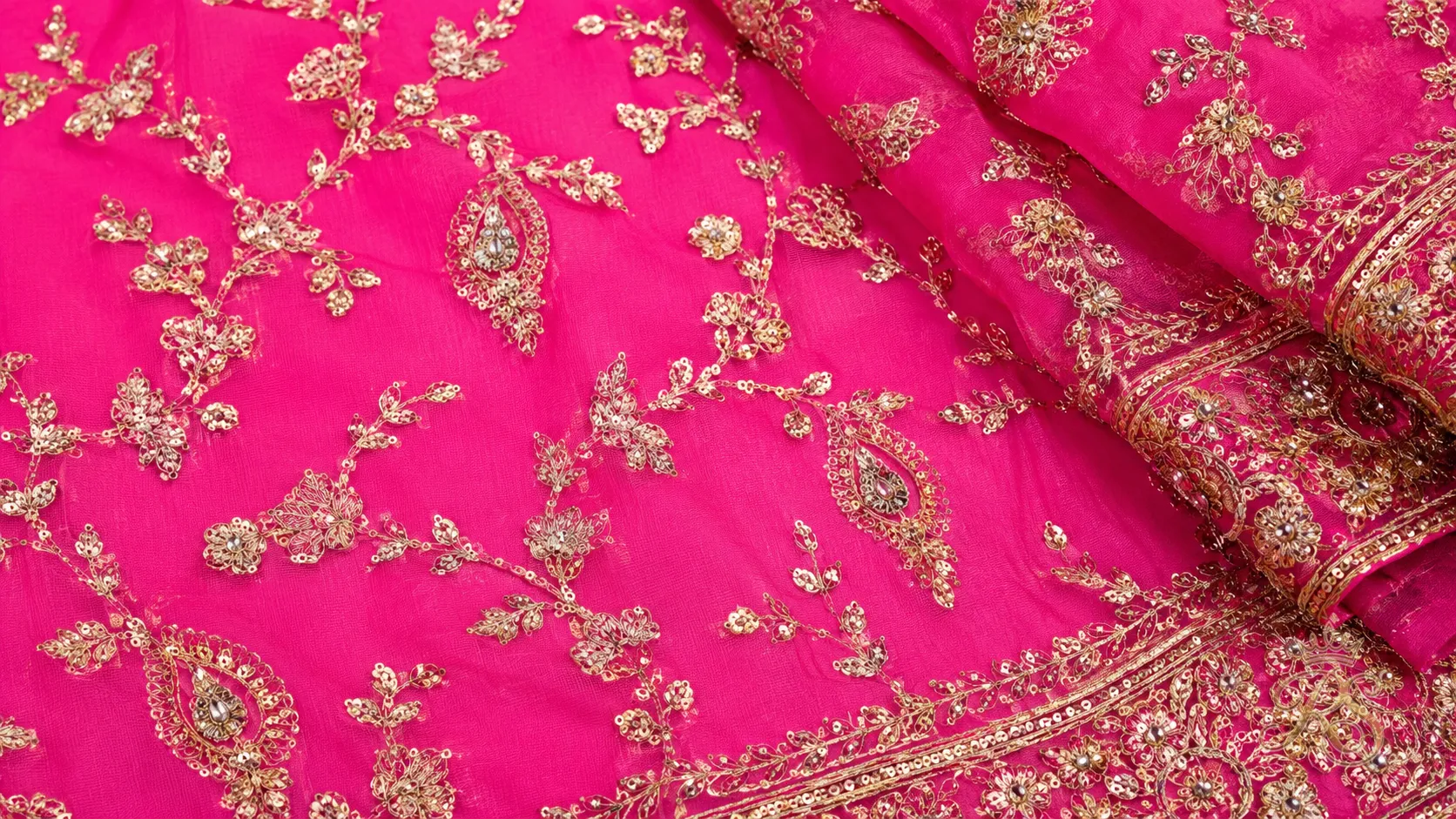 Rani pink couture bridal lehenga fabric swatch and embroidery detail