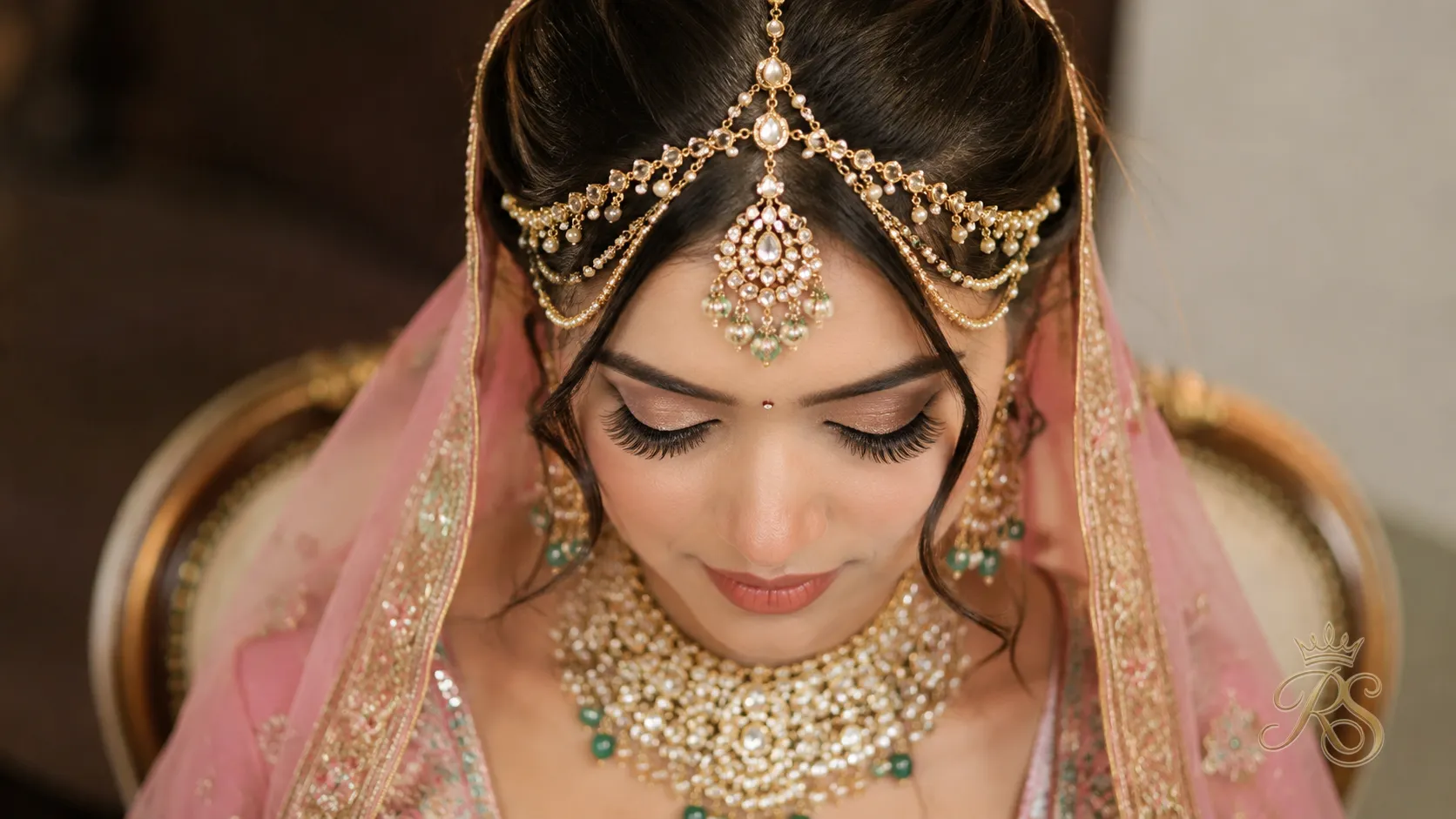 Bridal matha patti and maang tikka styling detail with lehenga