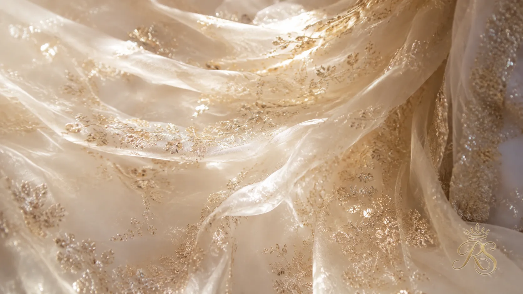 Tissue organza bridal lehenga fabric catching light, lightweight couture material