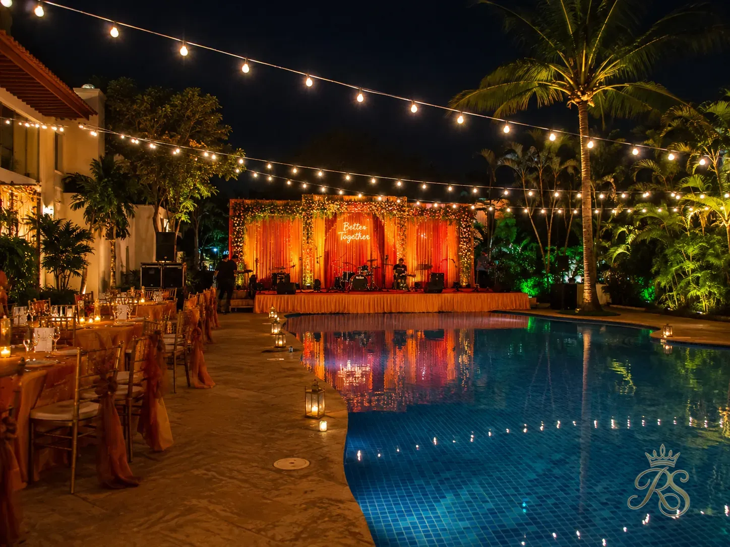 Wedding sangeet setup beside a resort swimming pool lit with string lights