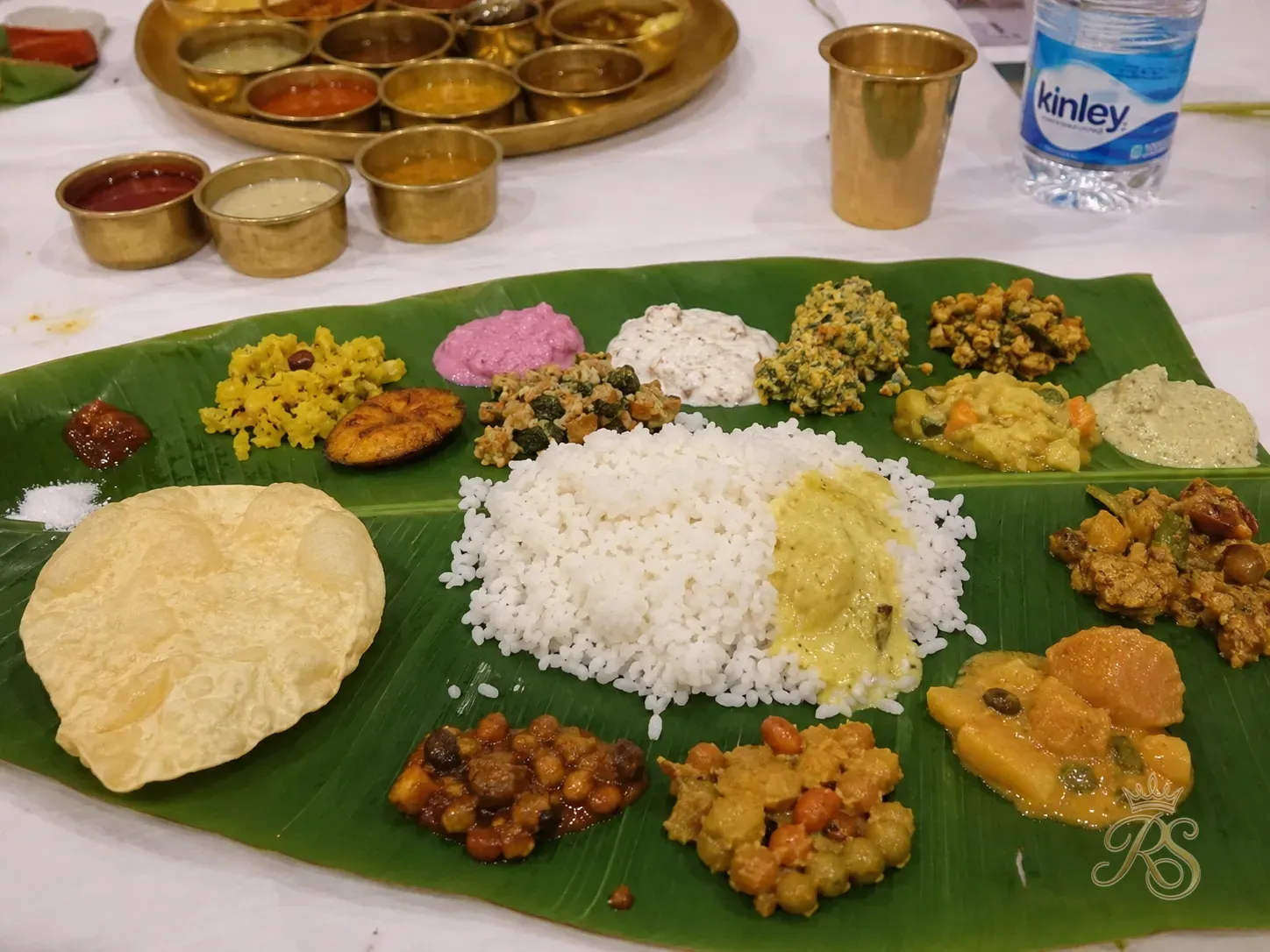 Beautifully arranged traditional Indian thali on banana leaf at a wedding dinner