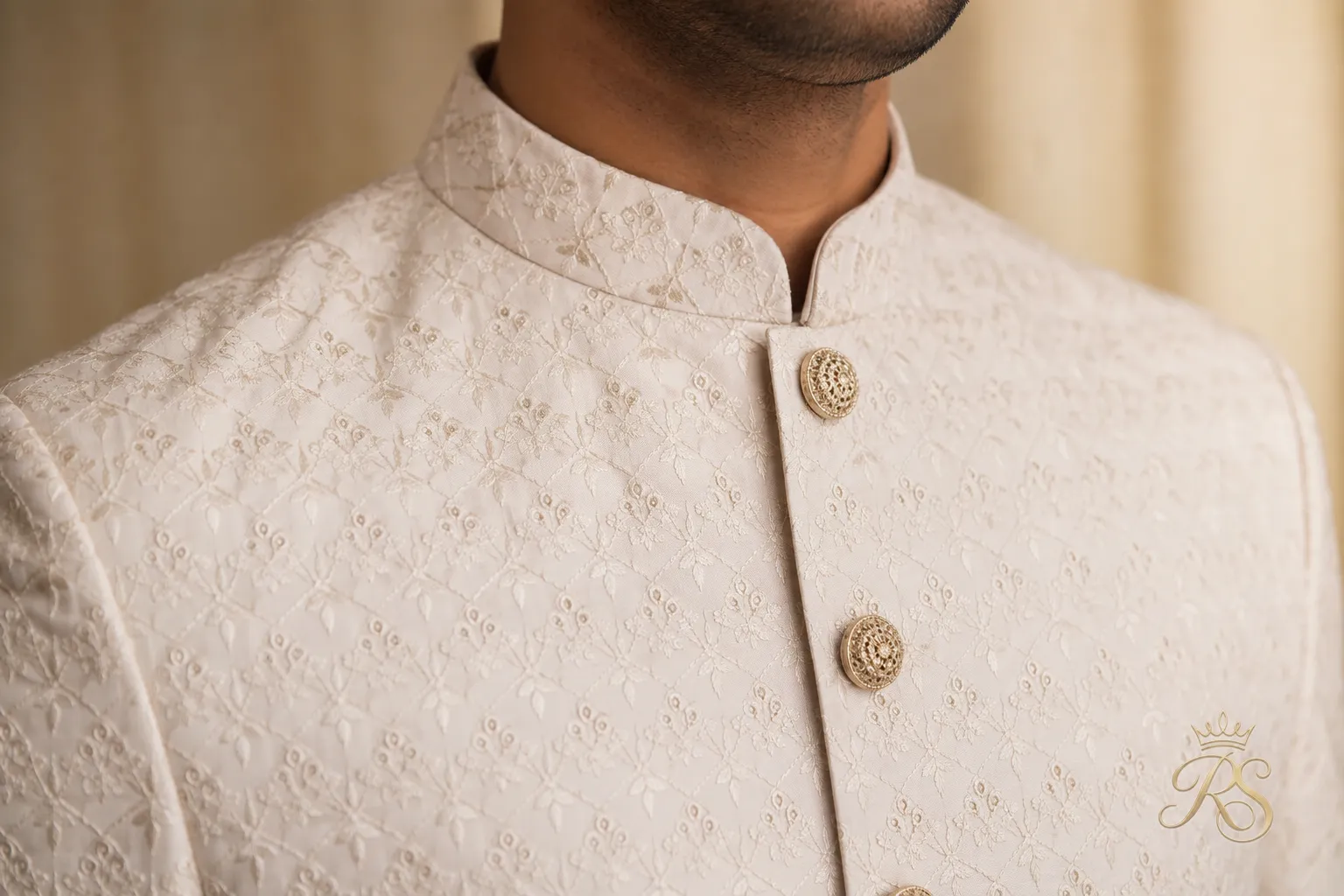 Close-up of bandhgala jacket button and collar detailing worn for a sangeet look