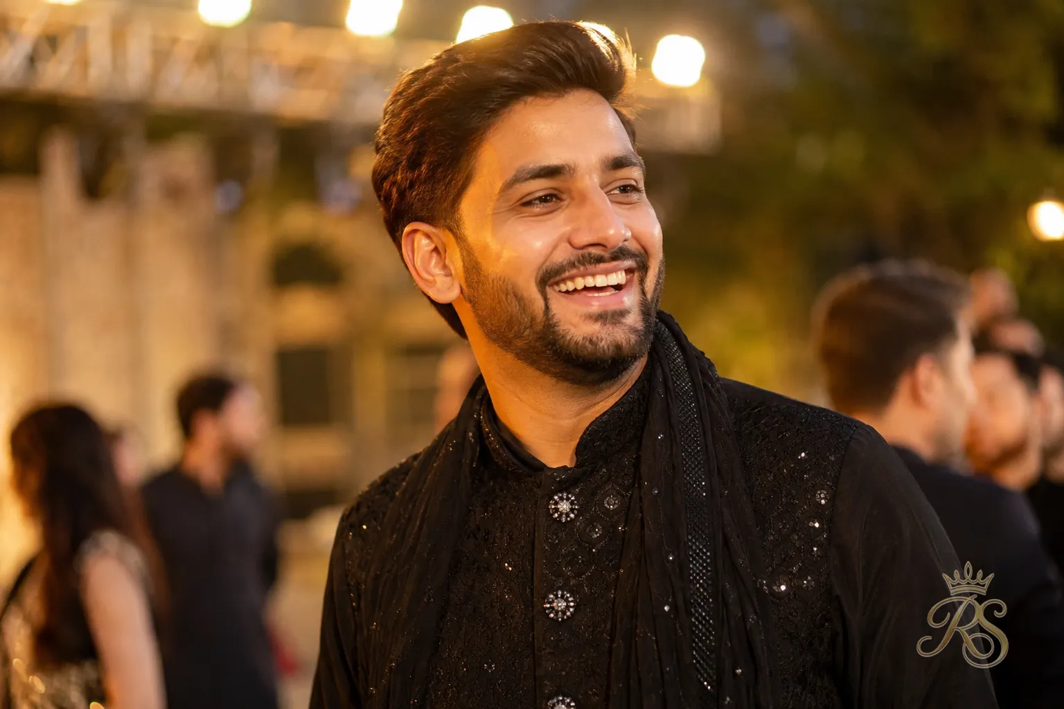Final portrait of a groom in a complete sangeet outfit smiling at his wedding celebration
