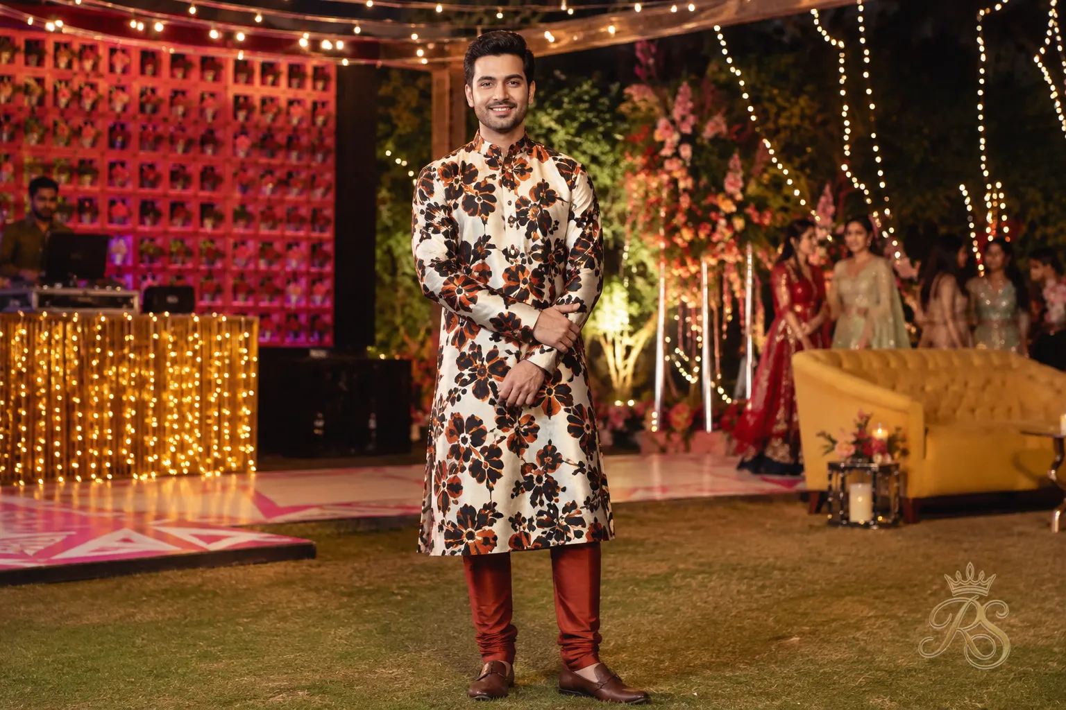 Groom wearing a printed silk kurta set with a contrasting churidar at a sangeet celebration