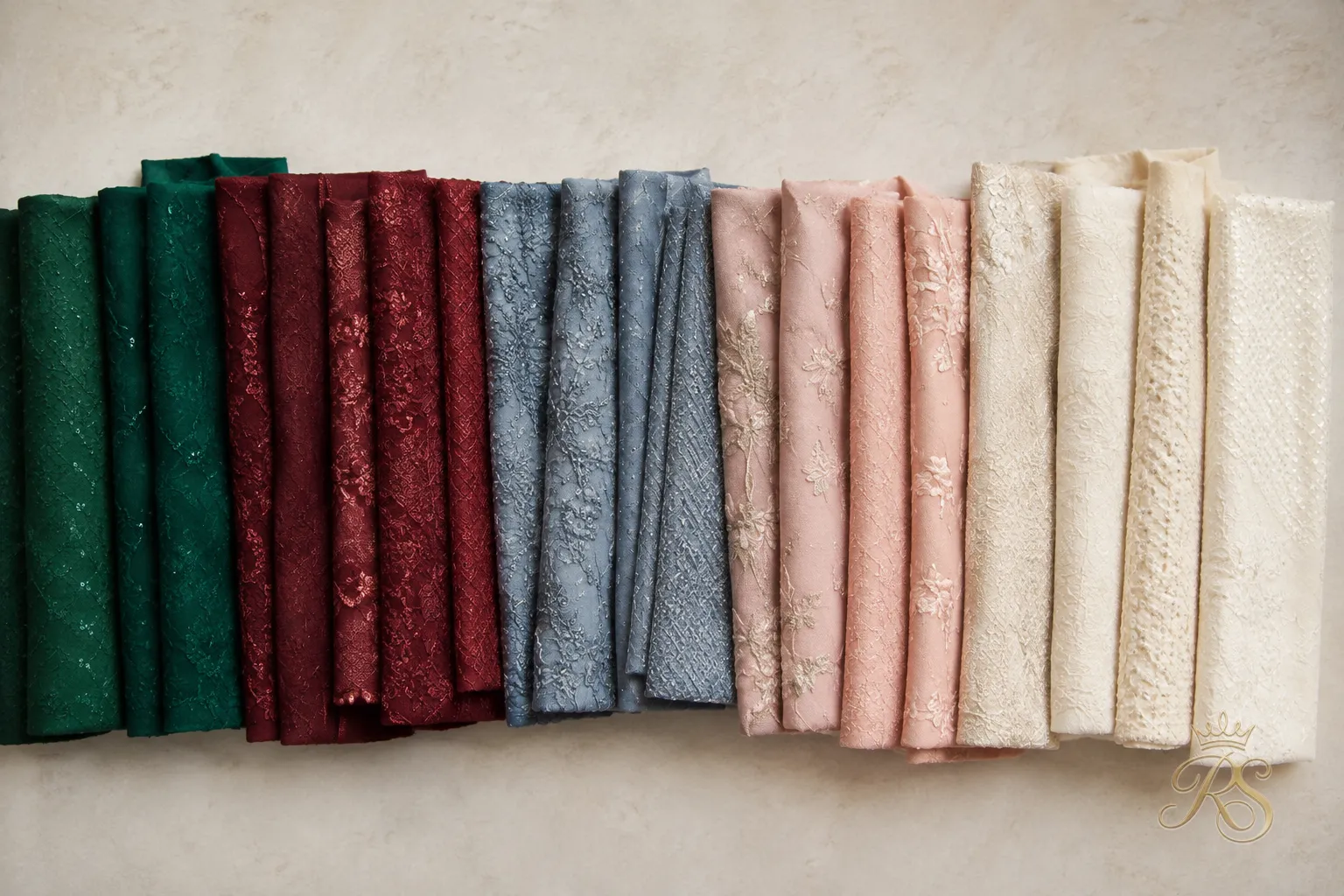 Flatlay of groom sangeet outfit color palette swatches in jewel tones and pastels