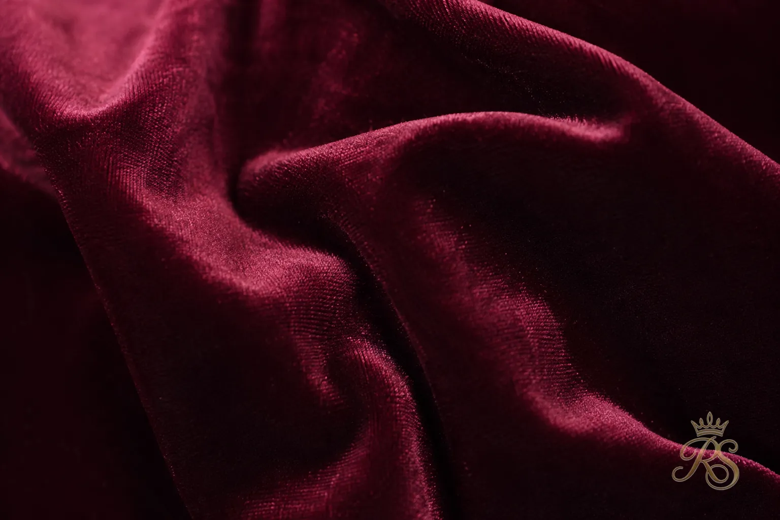 Macro close-up of rich velvet kurta fabric texture in a deep wine tone