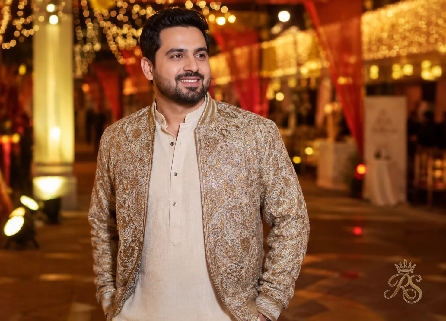 Groom in an embroidered silk bomber jacket over a kurta