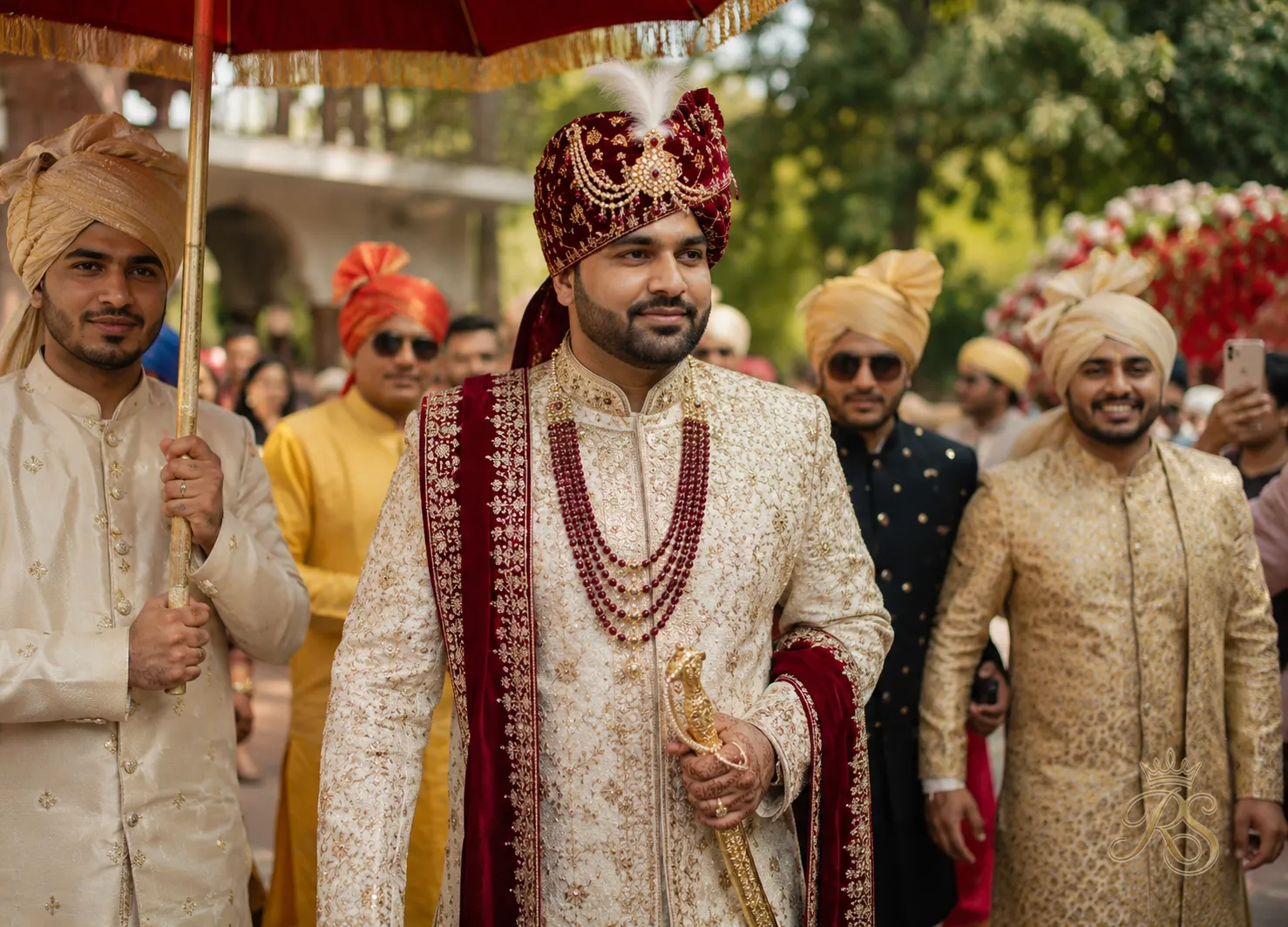 Groom in a heavily embroidered cream sherwani with a turban during the wedding ceremony