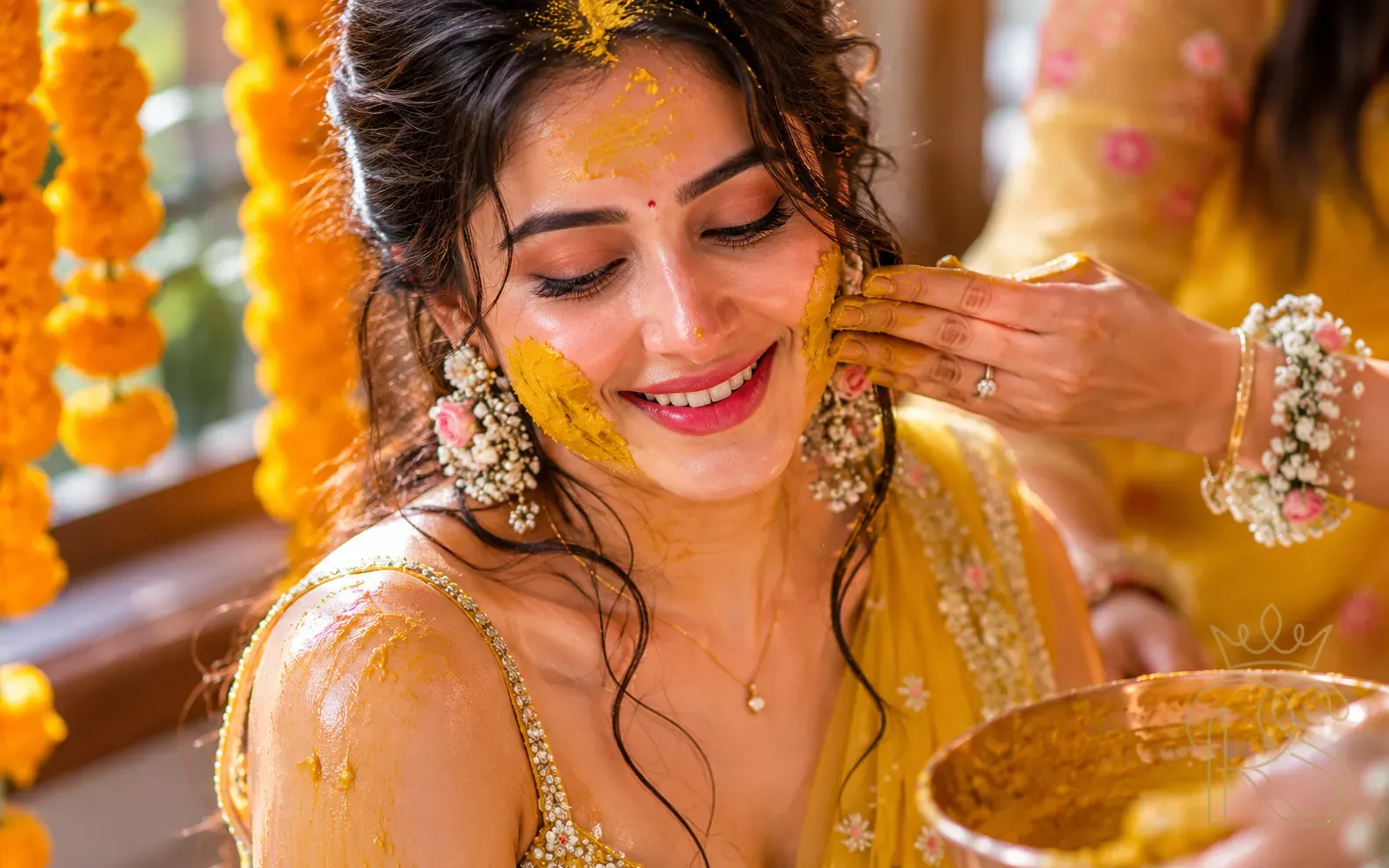 Close-up portrait of Indian bride with turmeric paste on face surrounded by marigold bokeh in soft natural light