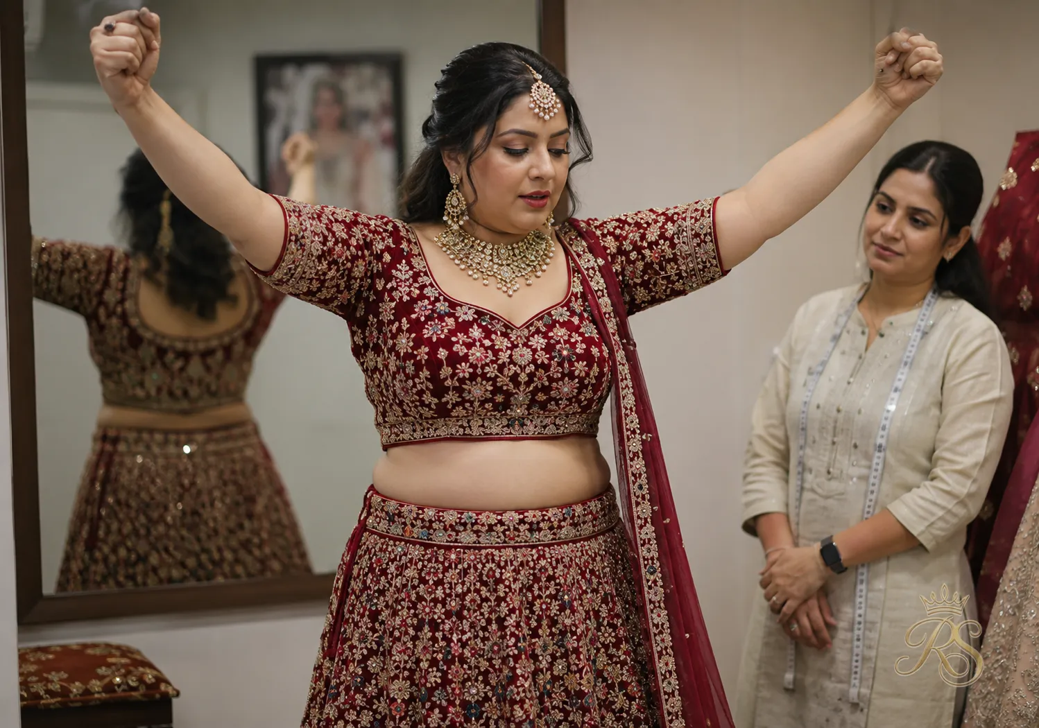 Tailor checking the fit of a bridal choli blouse on a bride during a trial