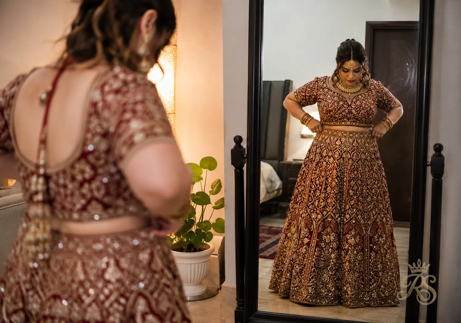 Bride checking the waistline fit of her bridal lehenga skirt in a mirror