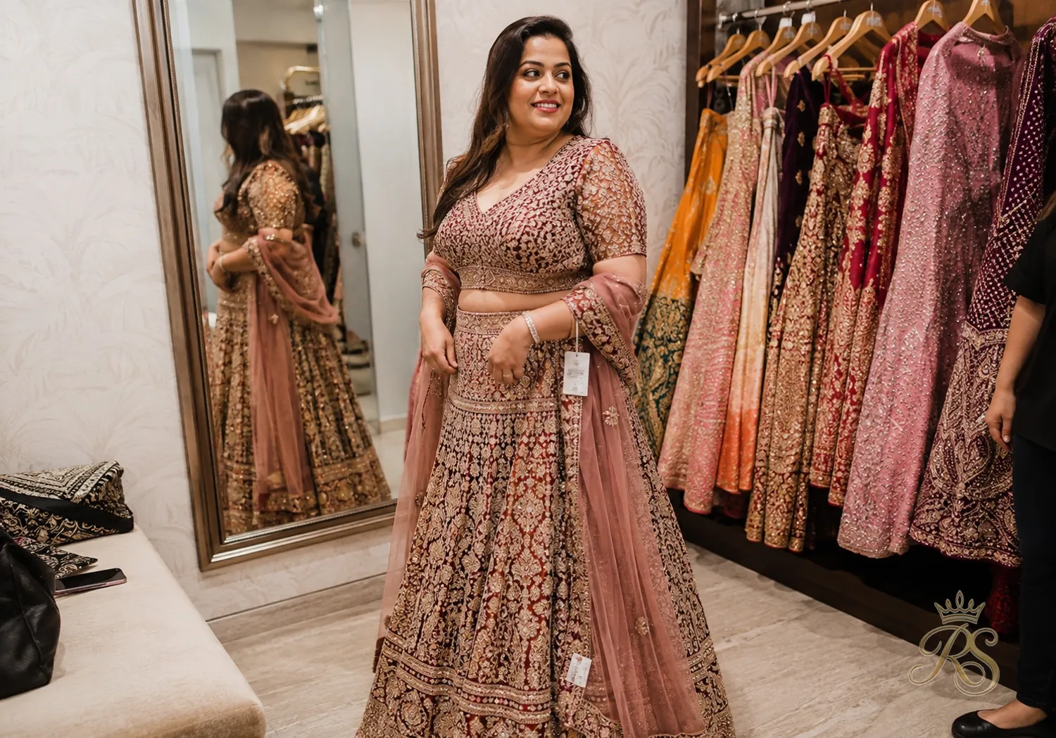 Bride trying on an off-the-rack bridal lehenga in a boutique fitting room