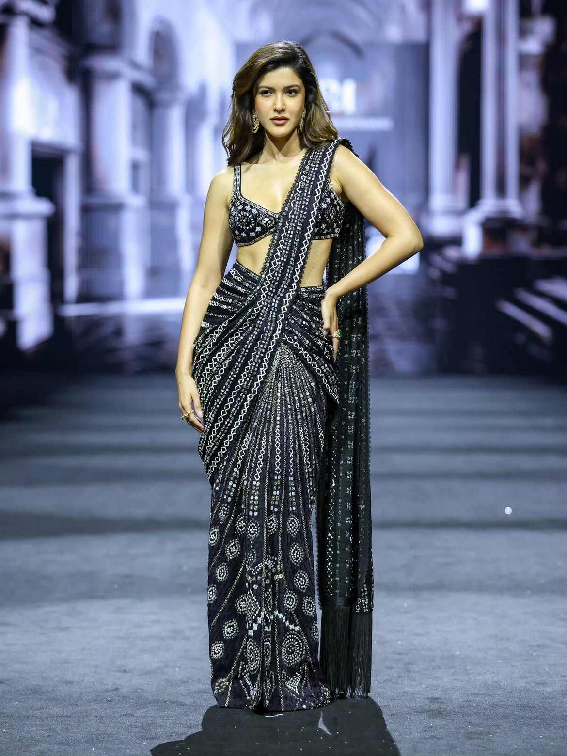 Shanaya Kapoor walks the runway for Ritika Mirchandani in a black and silver mirror-embroidered saree gown