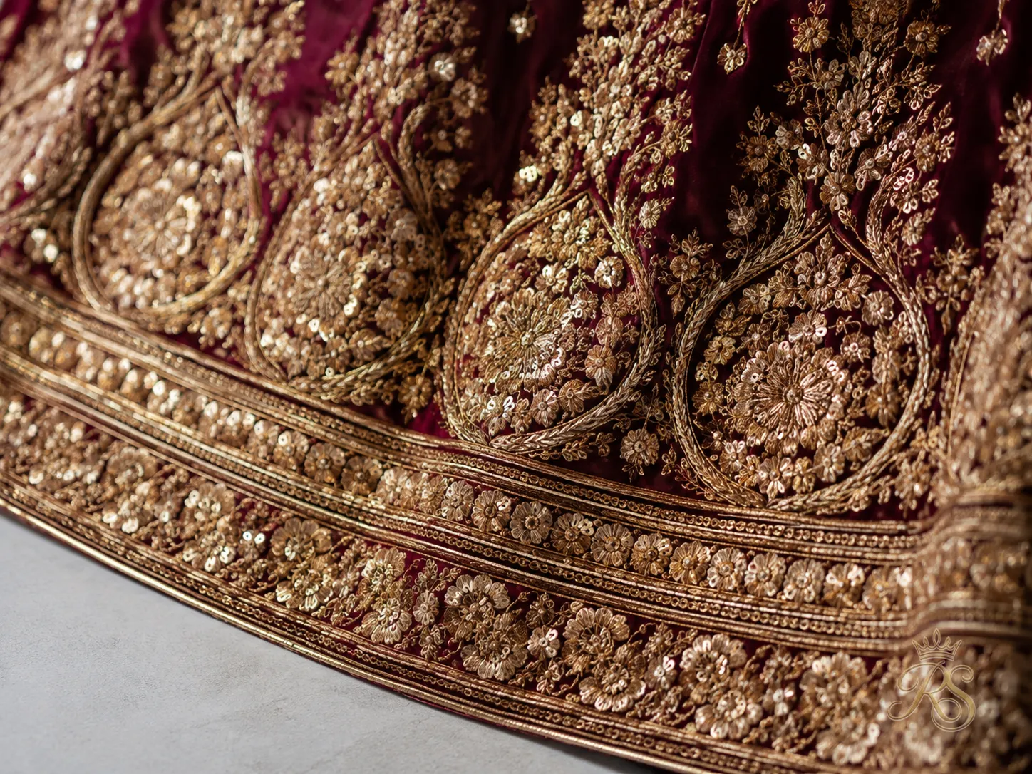 Antique gold threadwork detail on bridal lehenga border