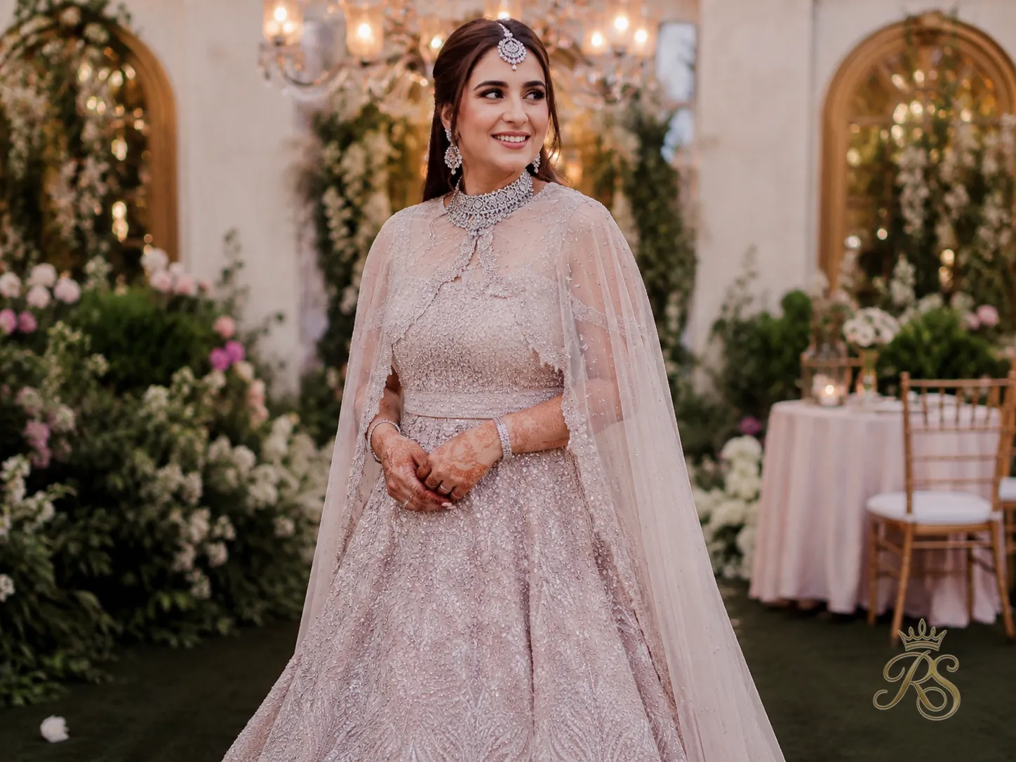 Bride wearing a cape-style shoulder drape instead of a traditional dupatta