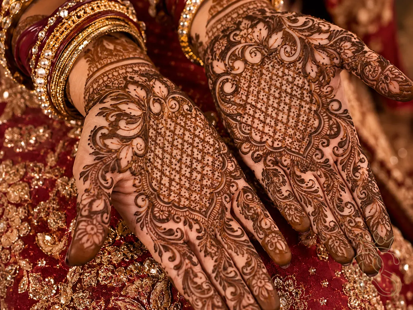 Indo-Arabic fusion mehndi combining intricate Rajasthani jali with bold Arabic florals in deep brown henna on bride's hands