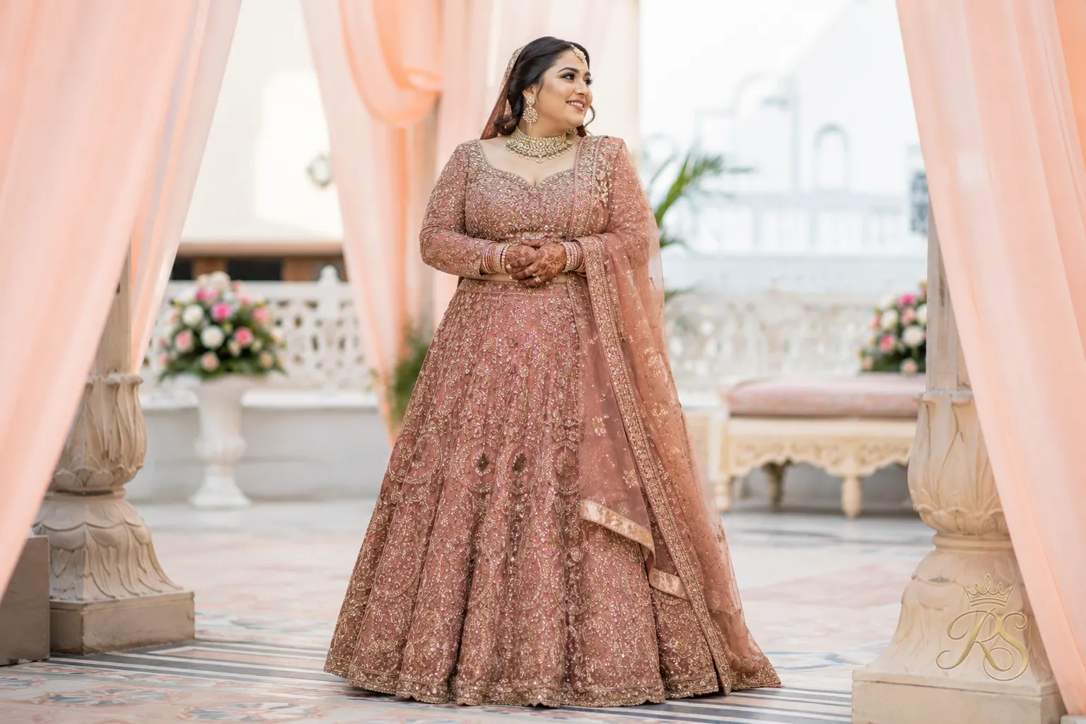 Plus size bride wearing an A-line lehenga that skims the waist and flares gently to the floor