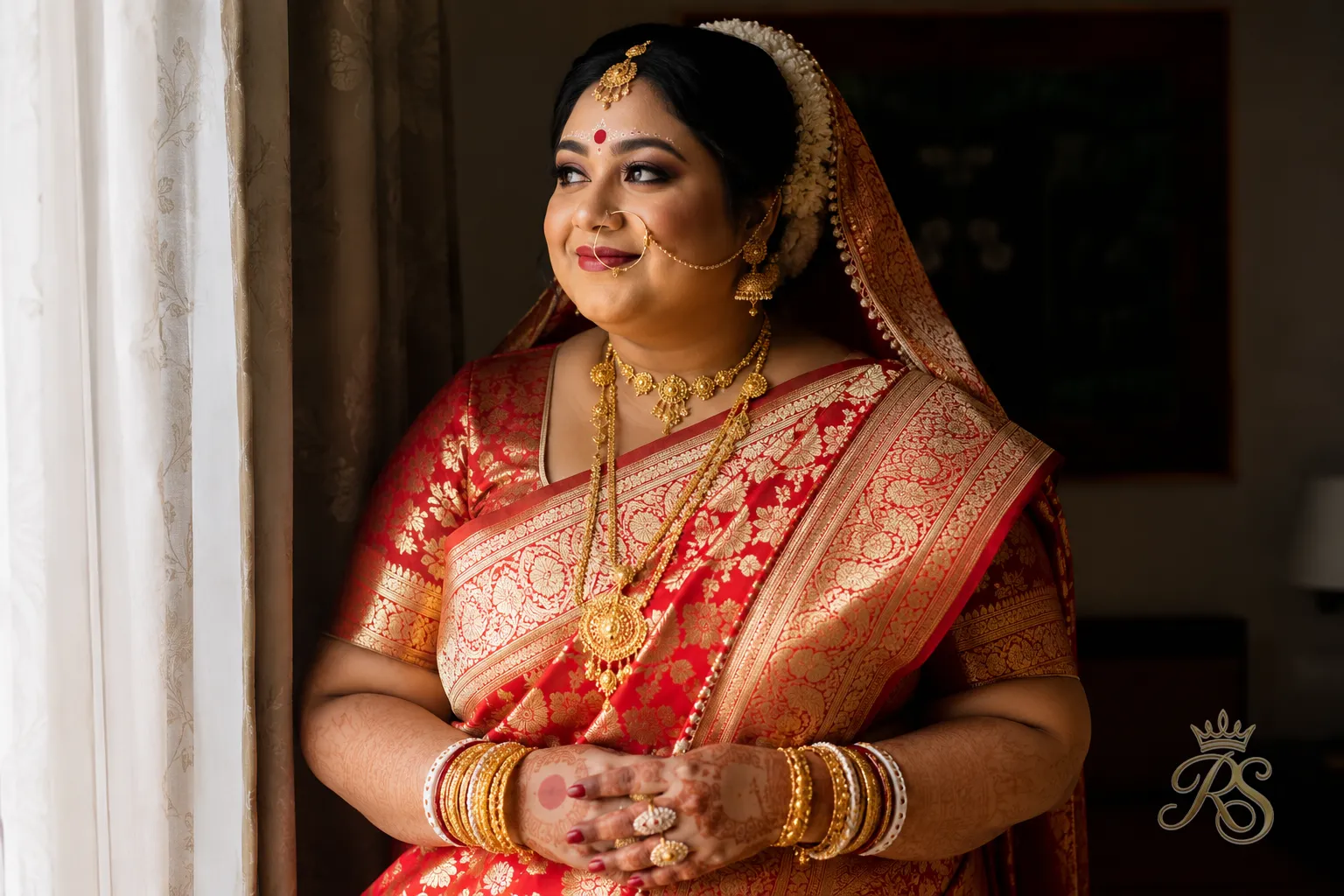 Plus size Bengali bride wearing a traditional red and gold Benarasi saree