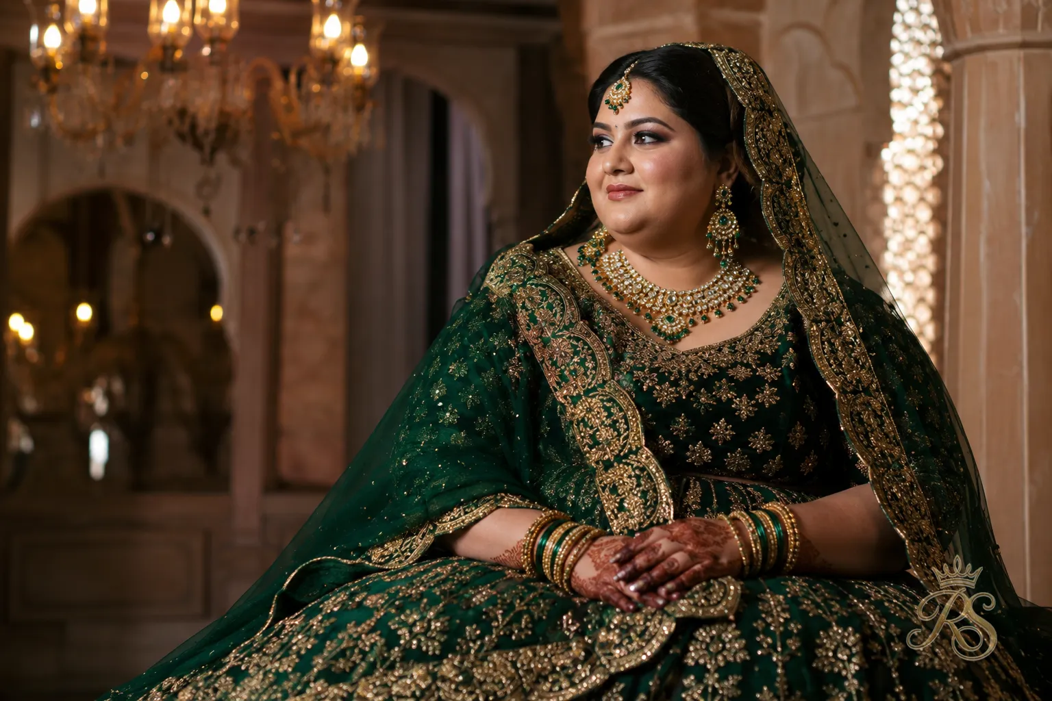 Plus size bride in a deep emerald jewel-toned bridal lehenga