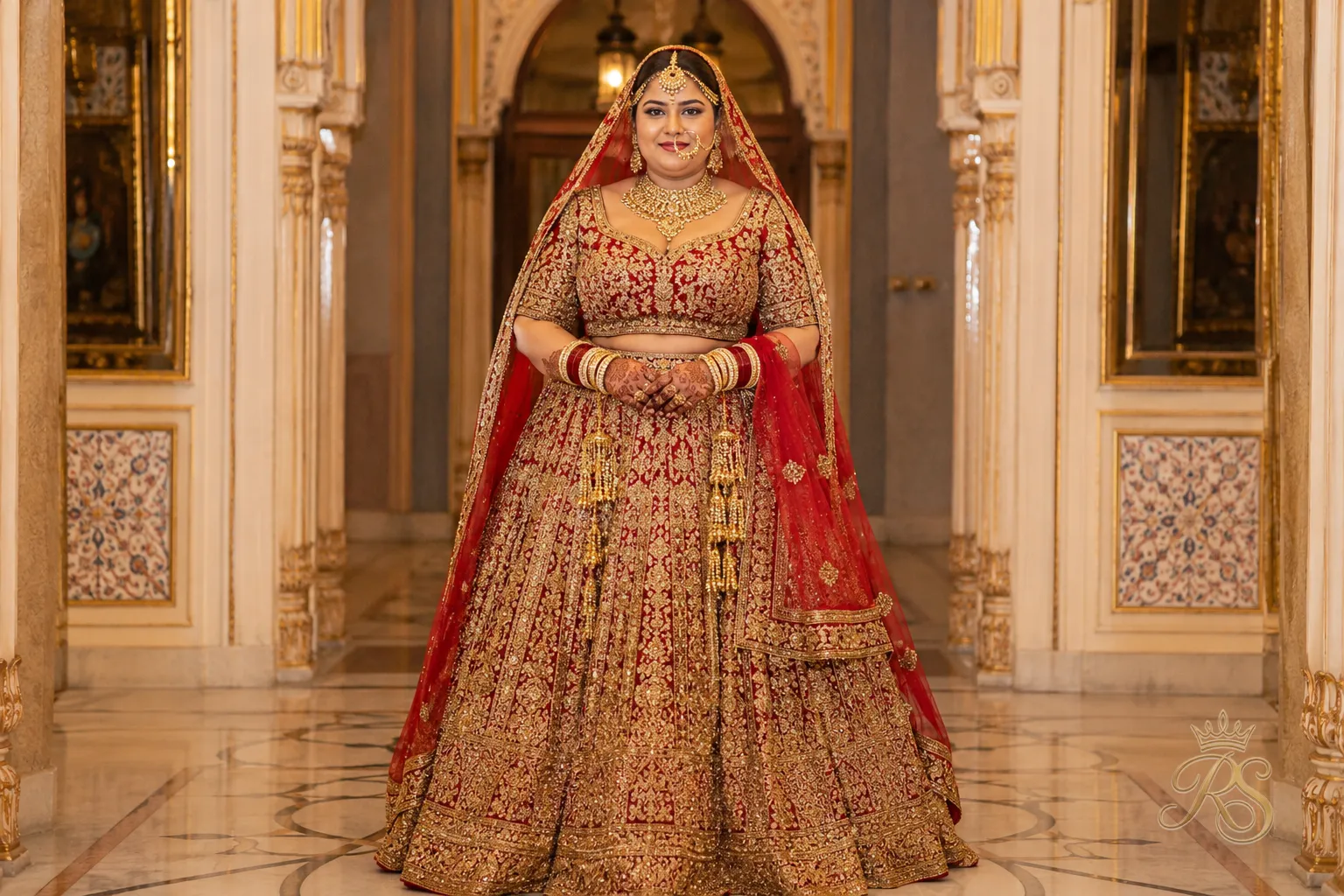 Plus size bride in a high-waisted embroidered lehenga with a fitted blouse