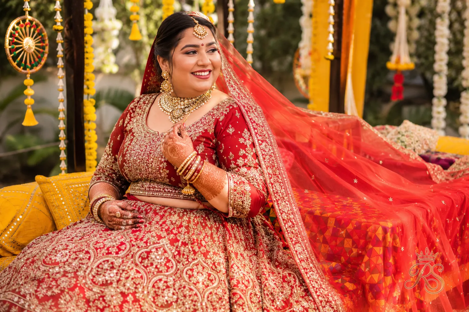 Plus size Punjabi bride in a richly embroidered heavy lehenga with a dupatta