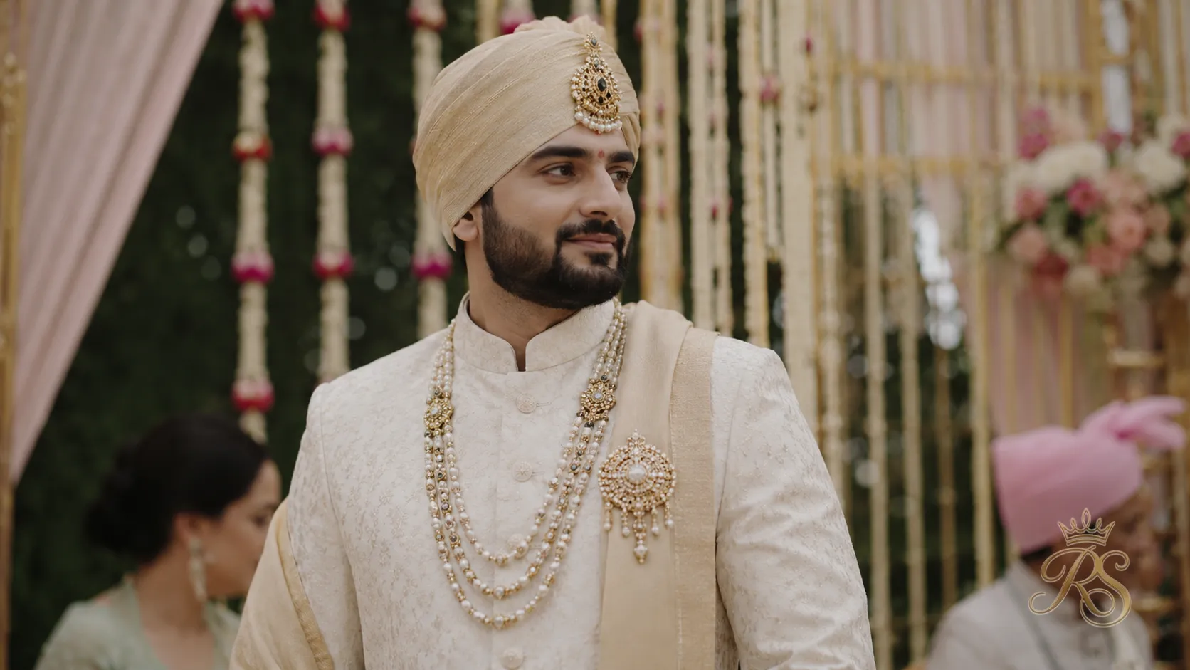 Groom wearing a polki brooch and layered mala for the wedding ceremony