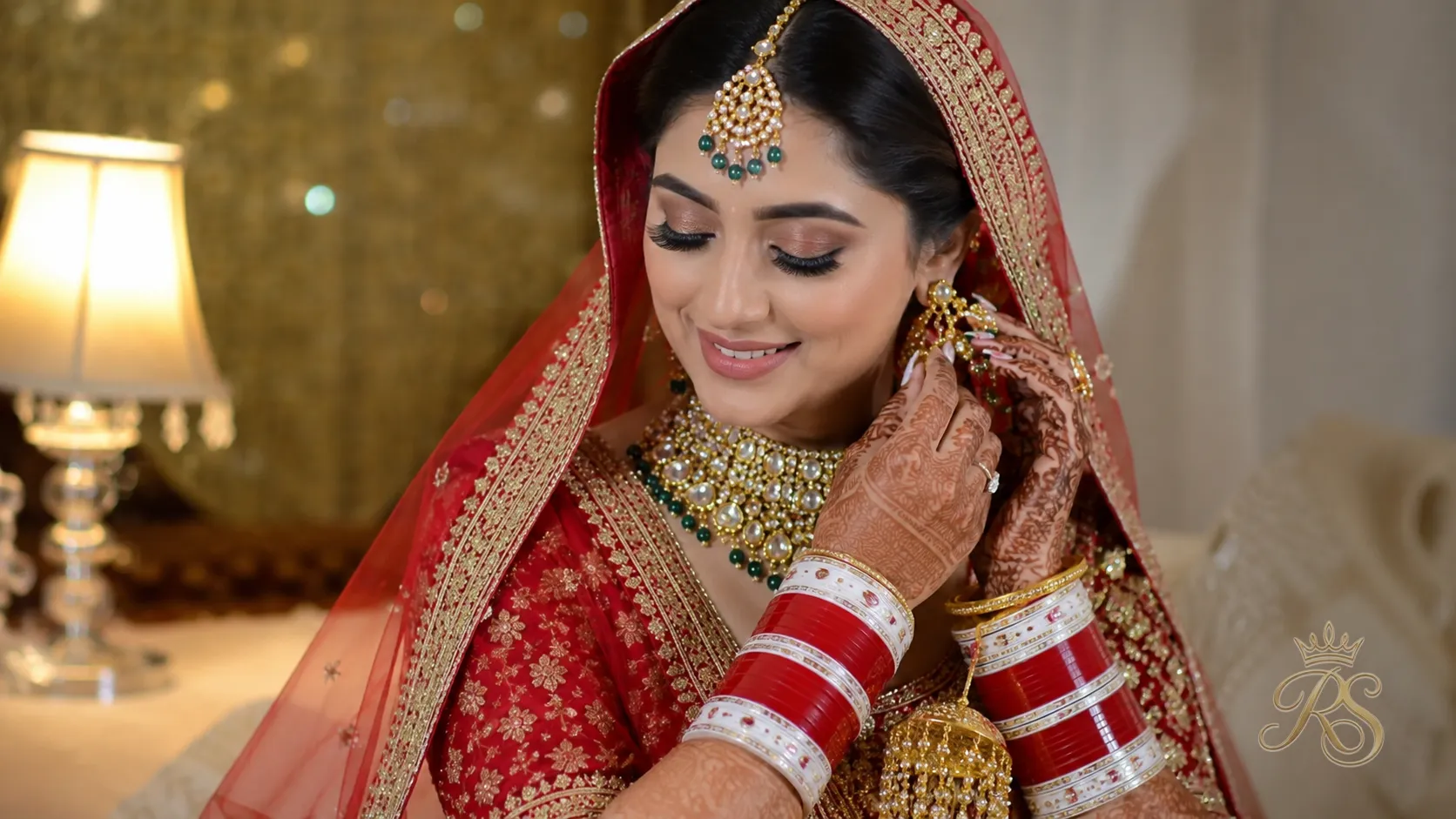 Punjabi bride wearing red and white chooda with a polki bridal set