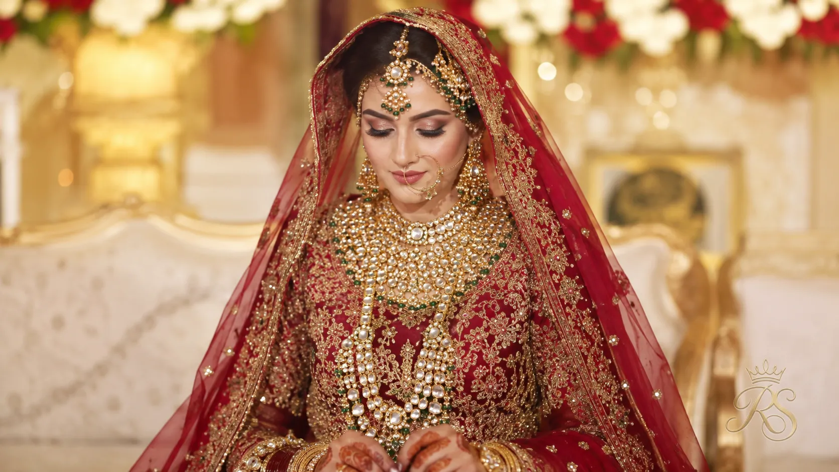 Bride on wedding day wearing the full heavy polki bridal set