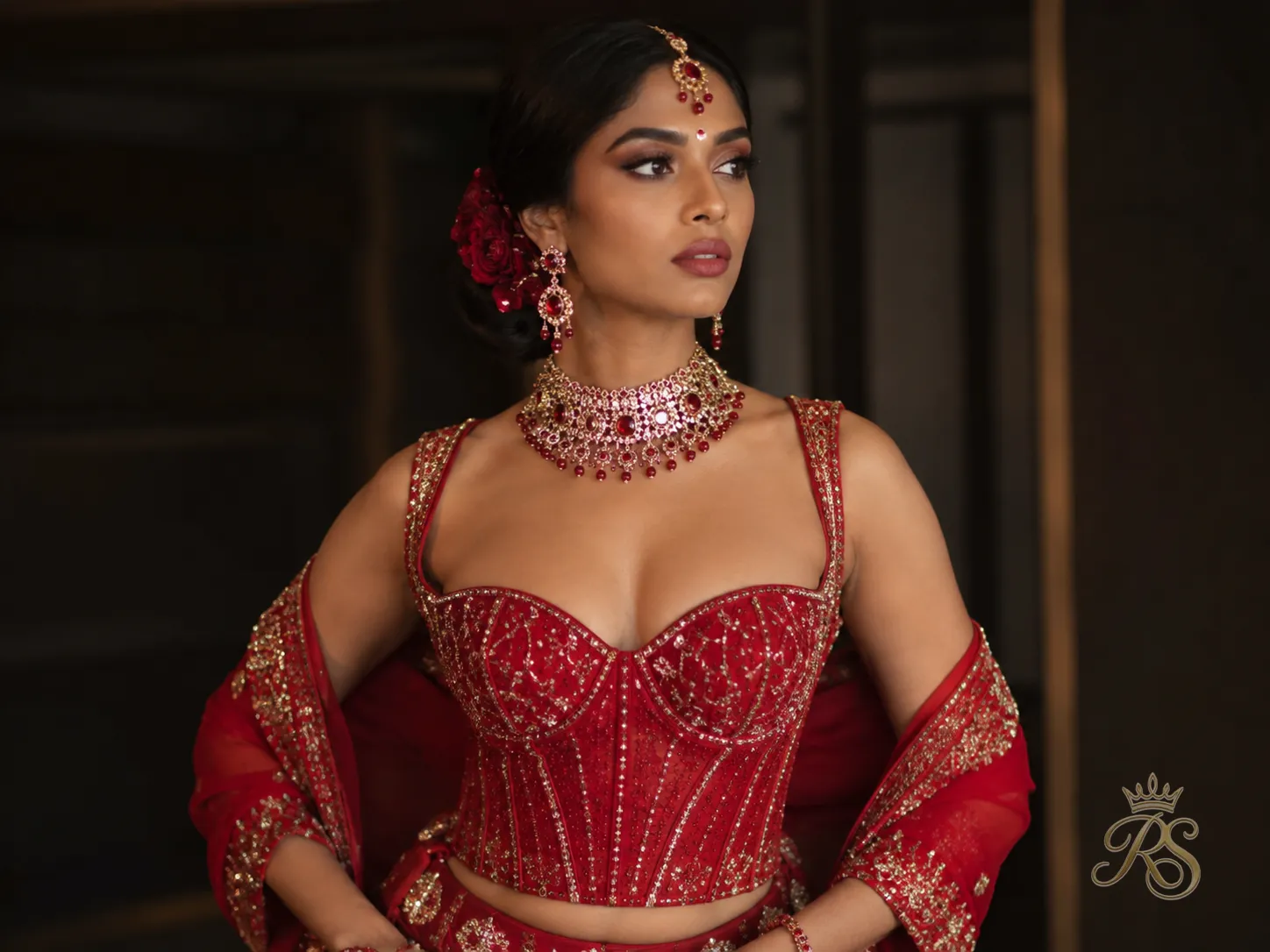 Red corset-style bridal blouse with a sculpted silhouette