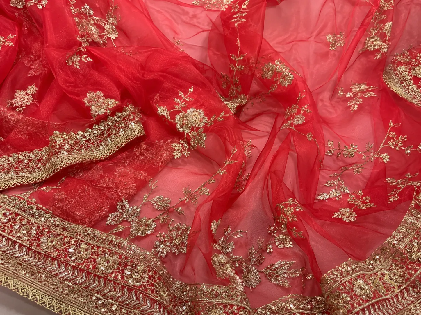 Lightweight red organza fabric for a bridal lehenga suited to daytime ceremonies