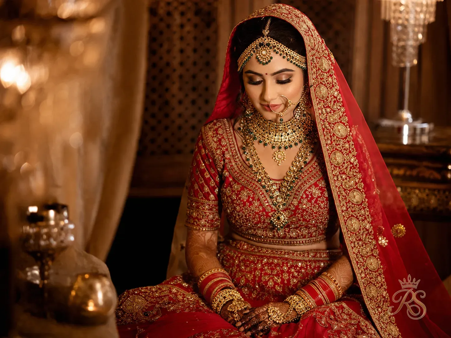 North Indian bride in red lehenga choli with heavy gold jewellery