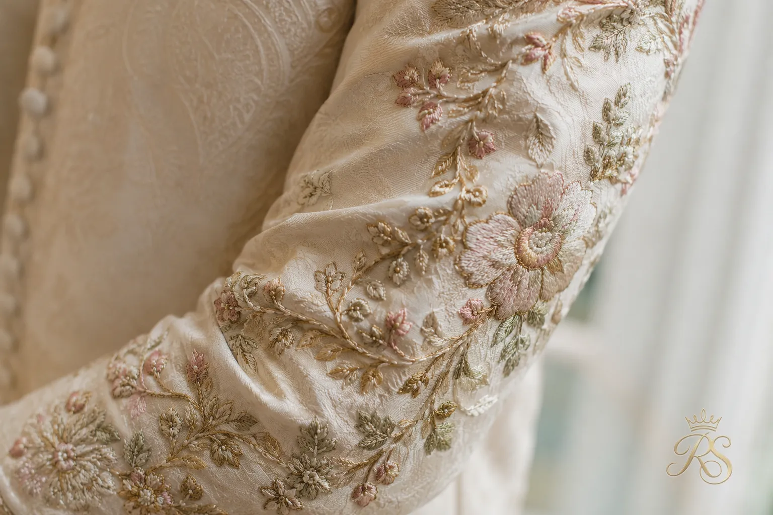 Resham thread embroidery detail on groom sherwani sleeve